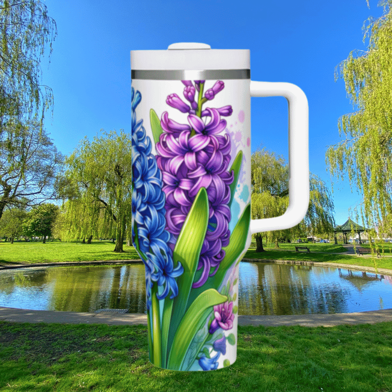 a large white coffee mug with purple flowers painted on it
