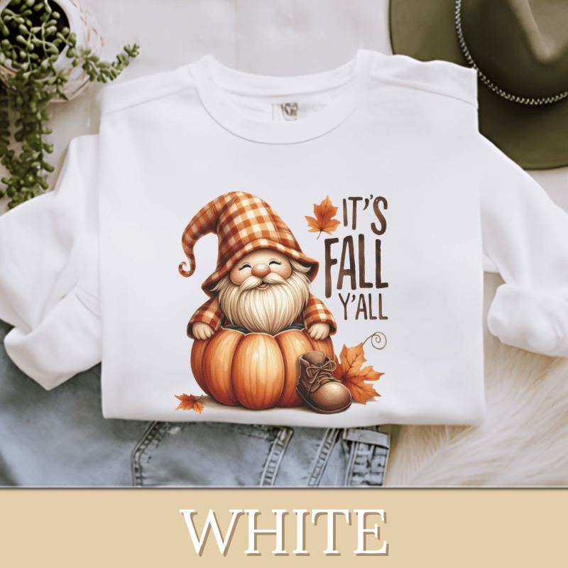 a white shirt with an image of a gnome sitting on top of a pumpkin
