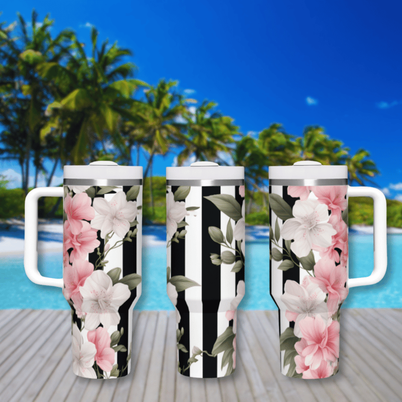 three travel mugs sitting on a wooden deck next to a pool