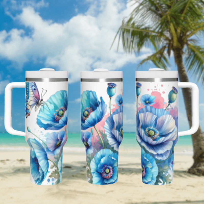 three travel mugs on a beach with a palm tree in the background