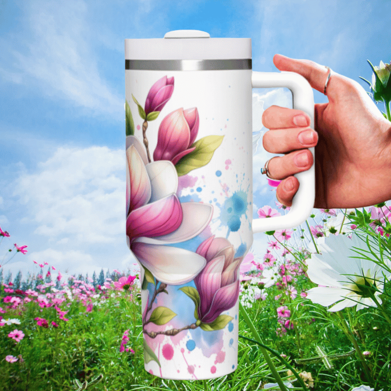 a hand holding a coffee mug in a field of flowers
