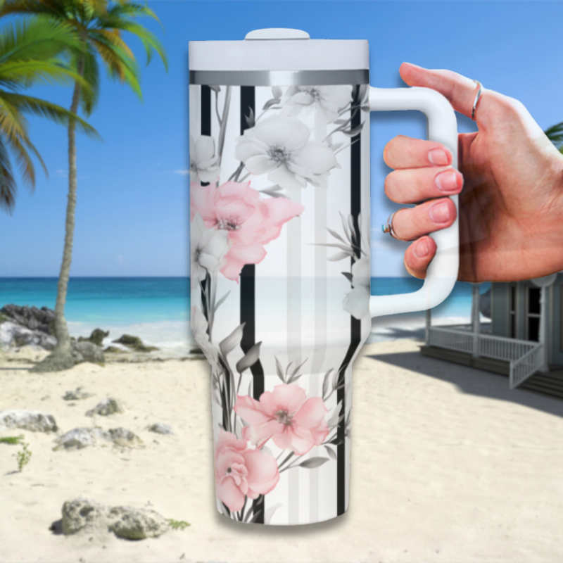 a person holding a coffee mug on a beach