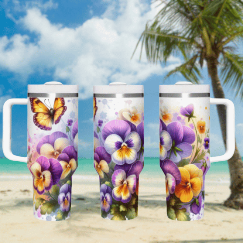 three travel mugs sitting on a beach with a palm tree in the background