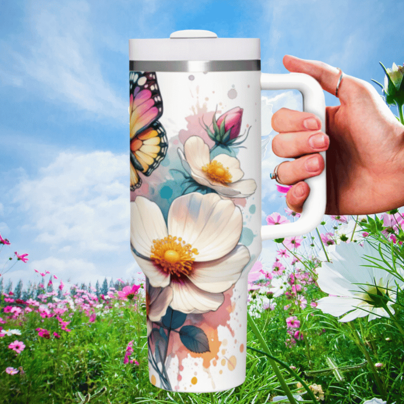 a person holding a coffee mug in a field of flowers