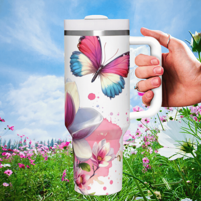 a hand holding a coffee mug in a field of flowers