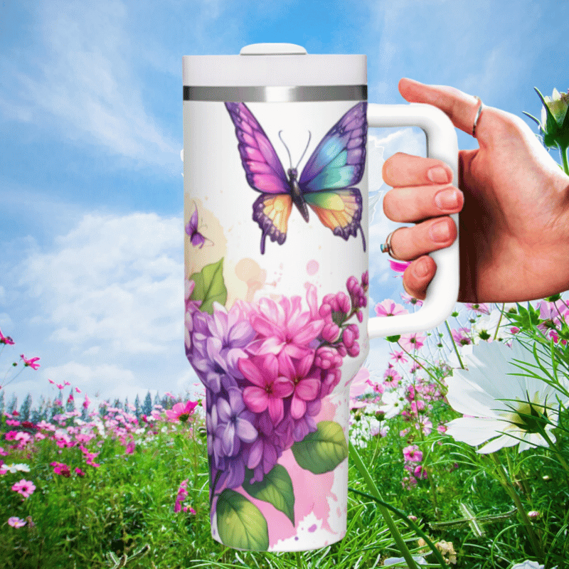 a hand holding a coffee mug in a field of flowers