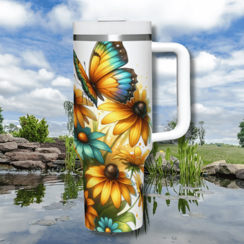 a white coffee mug with yellow and blue butterflies on it