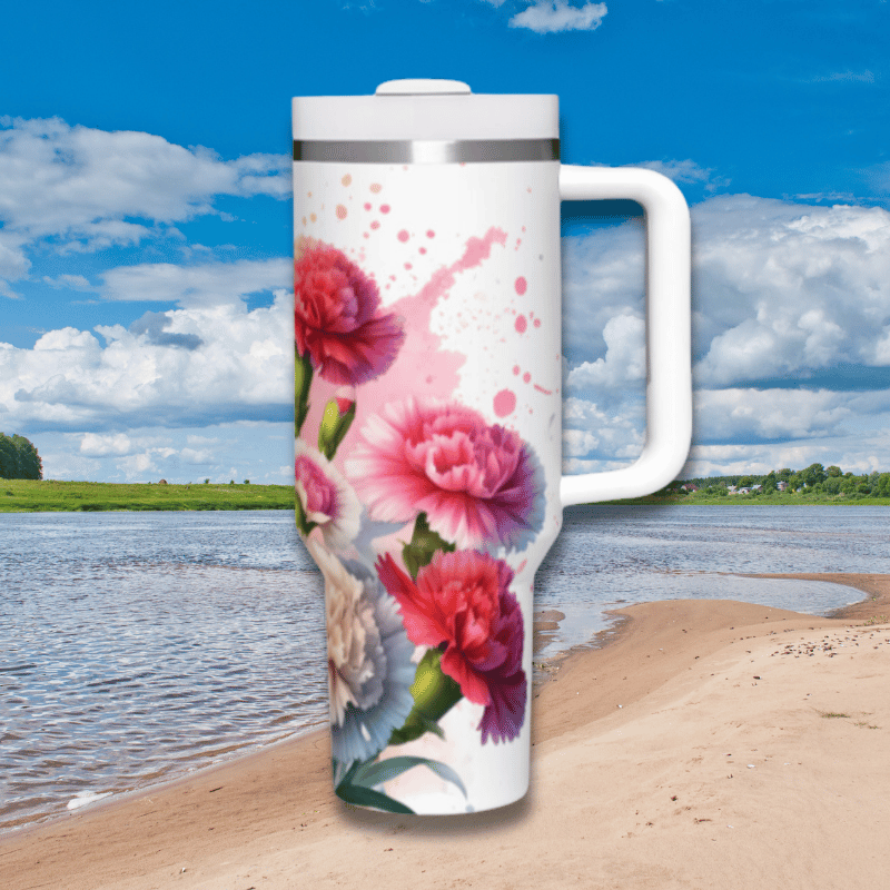 a white travel mug with pink flowers painted on it