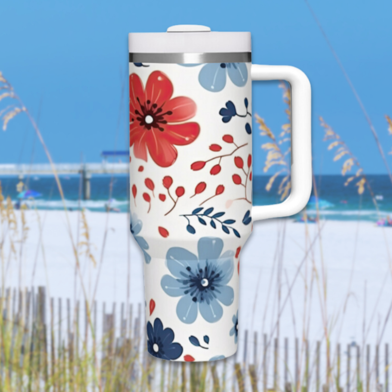 a travel mug with a flower design on it