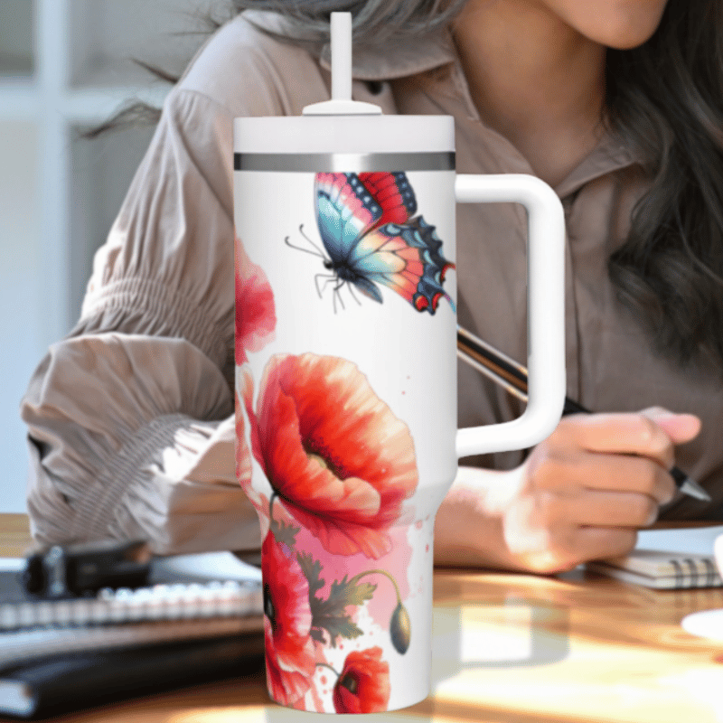 a woman sitting at a desk holding a coffee cup