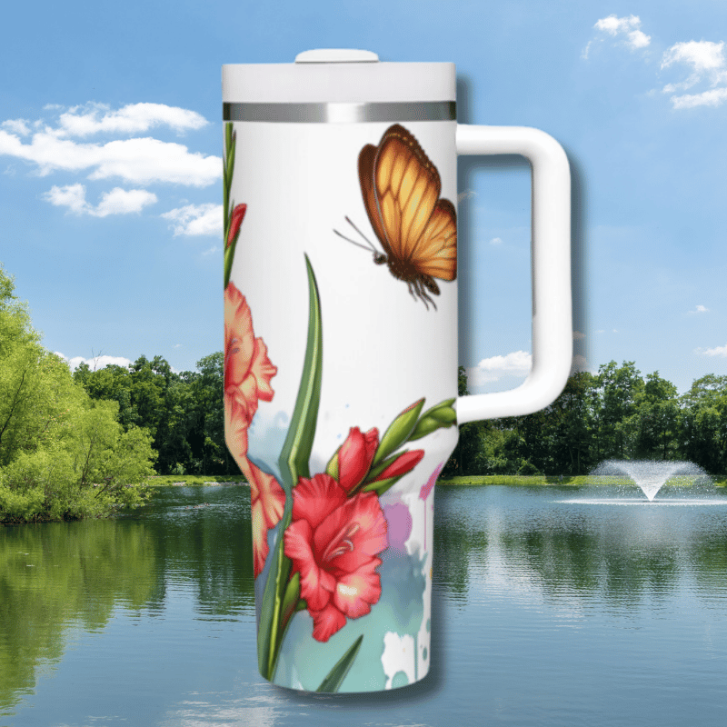 a picture of a butterfly and flowers on a travel mug