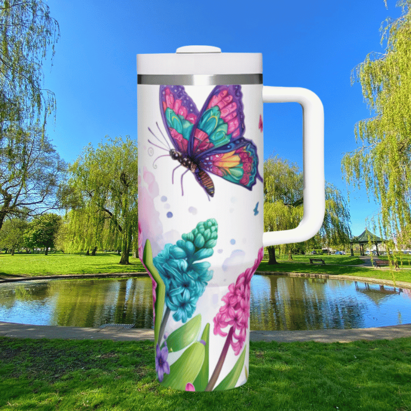 a colorful butterfly painted on a travel mug