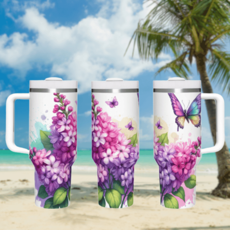 three travel mugs on a sandy beach with a palm tree in the background