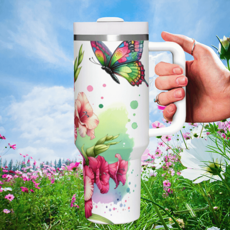 a hand holding a coffee mug in a field of flowers