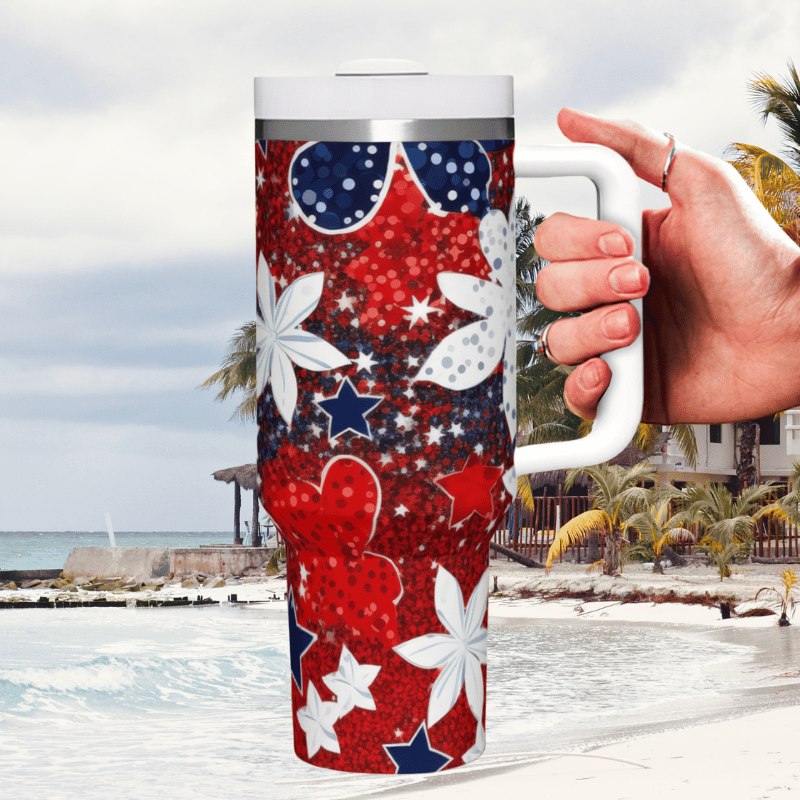 a hand holding a red, white and blue travel mug