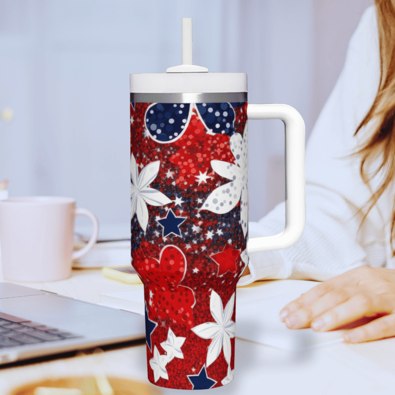 a woman sitting at a desk with a red, white, and blue coffee mug