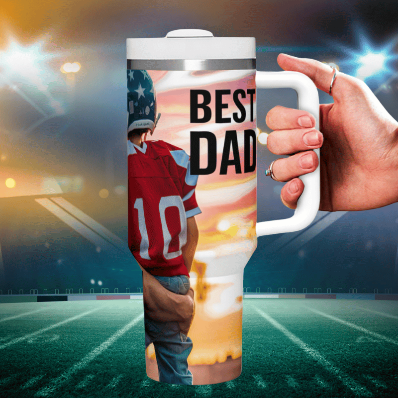 a hand holding a coffee mug with a picture of a football player on it