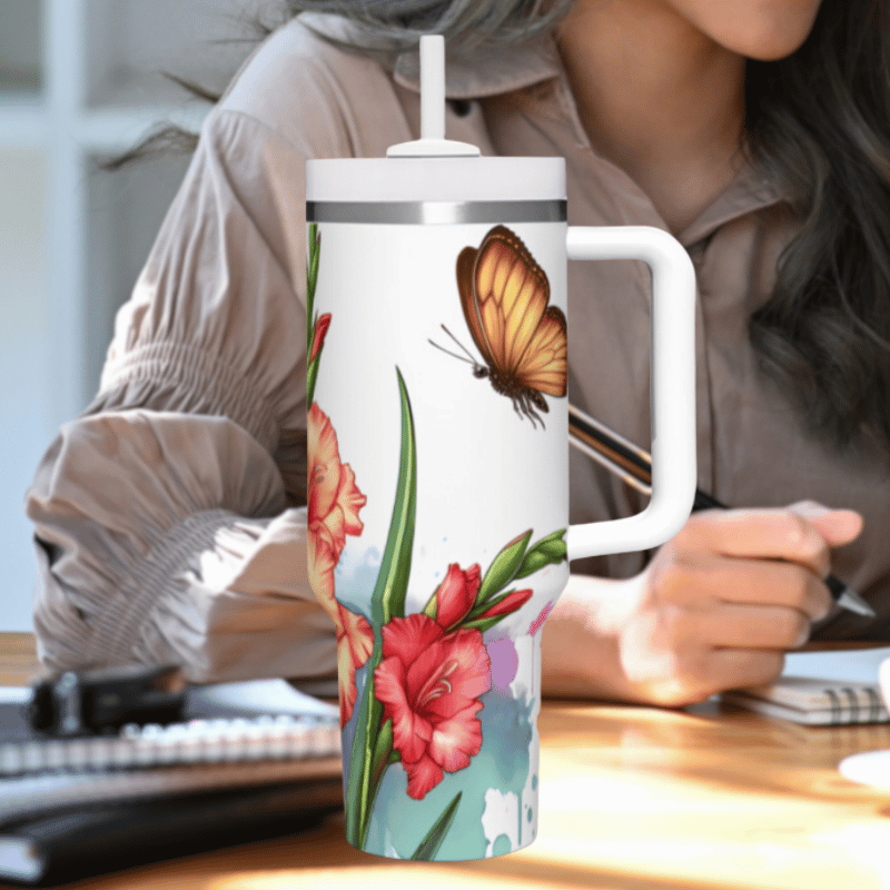 a woman sitting at a desk holding a coffee mug