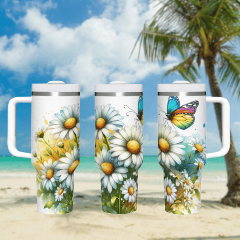 three travel mugs on a sandy beach with a palm tree in the background