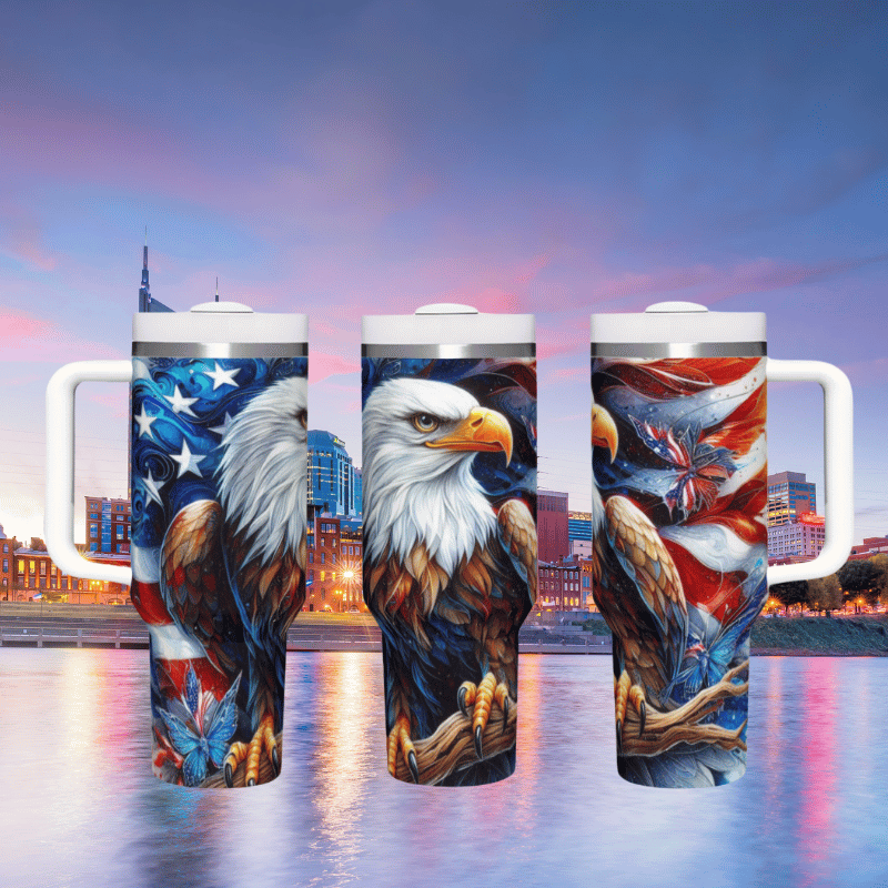 a group of three coffee mugs with an eagle painted on them