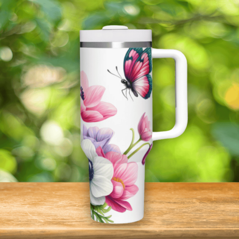 a white travel mug with a colorful butterfly on it