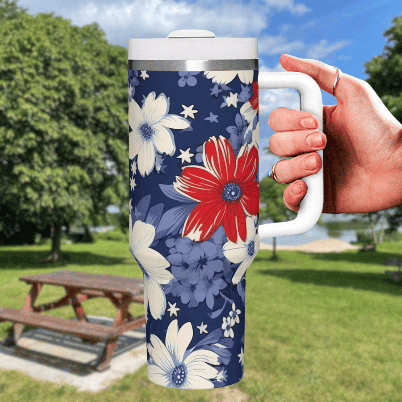 a hand holding a coffee mug in front of a park bench