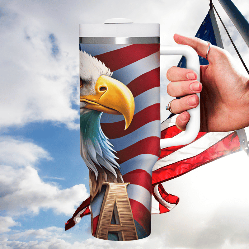 a hand holding a coffee mug with an eagle on it