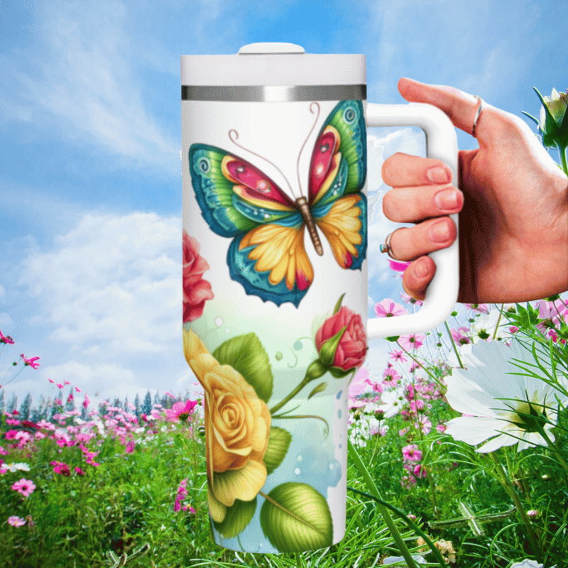 a hand holding a coffee mug in a field of flowers