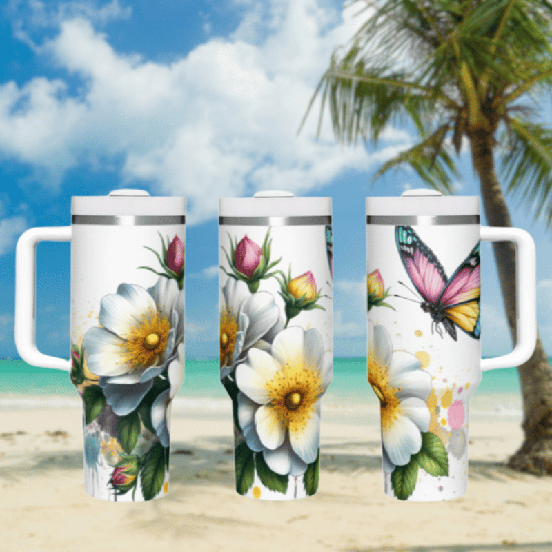 three travel mugs on a beach with a palm tree in the background