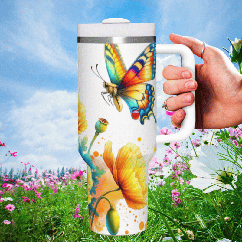 a hand holding a coffee mug in a field of flowers