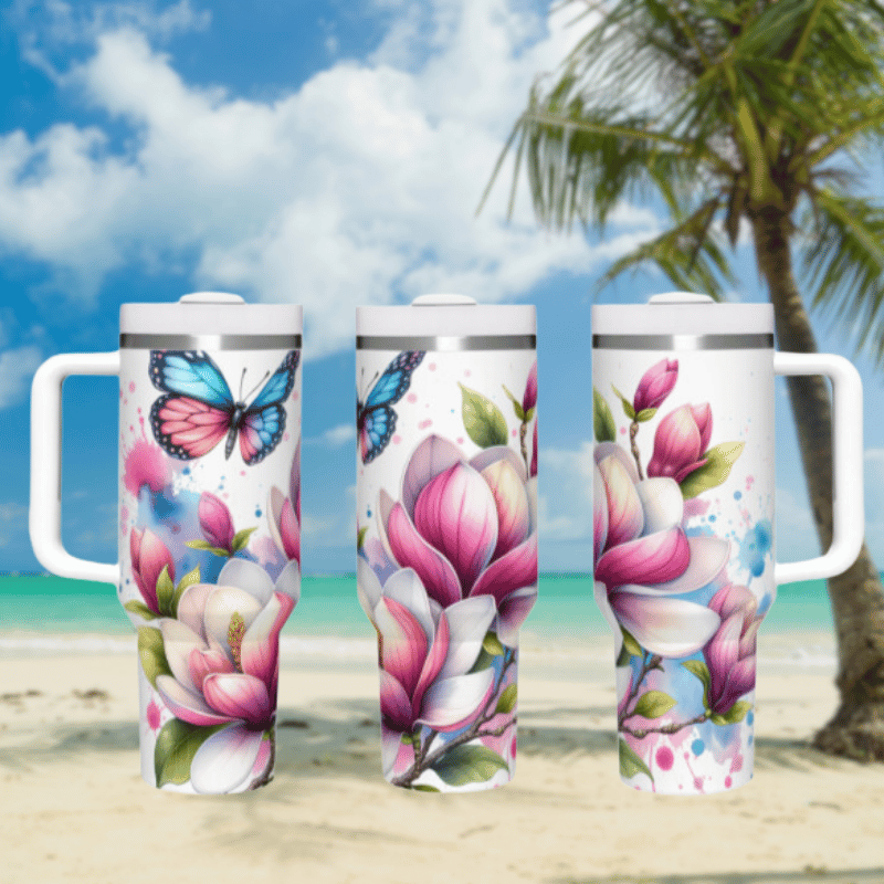 three travel mugs on a beach with a palm tree in the background