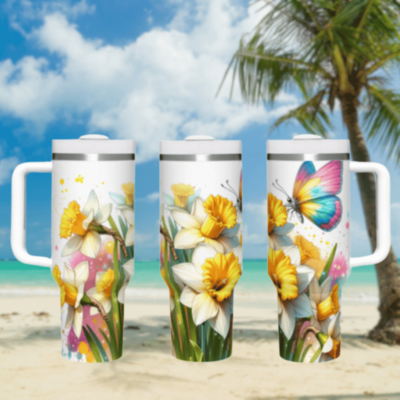 three travel mugs on a beach with a palm tree in the background