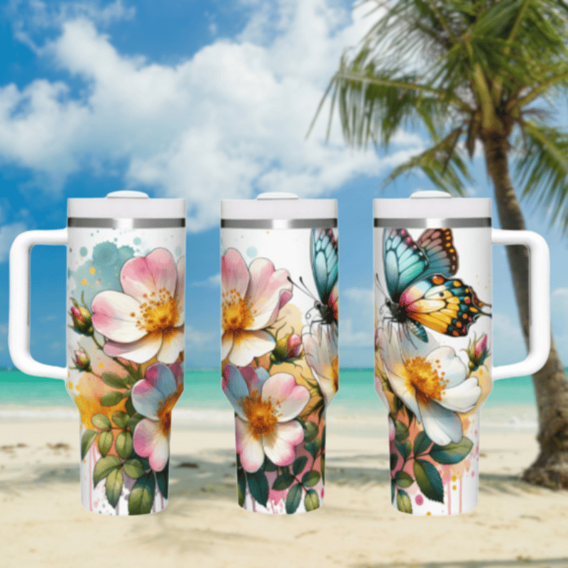 three travel mugs on a sandy beach with a palm tree in the background