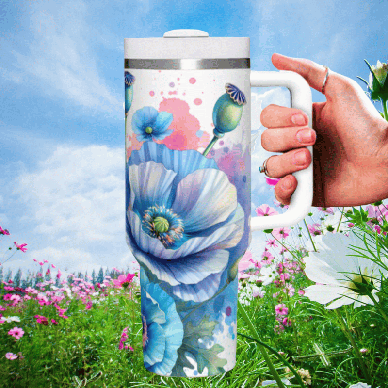 a hand holding a coffee mug in a field of flowers