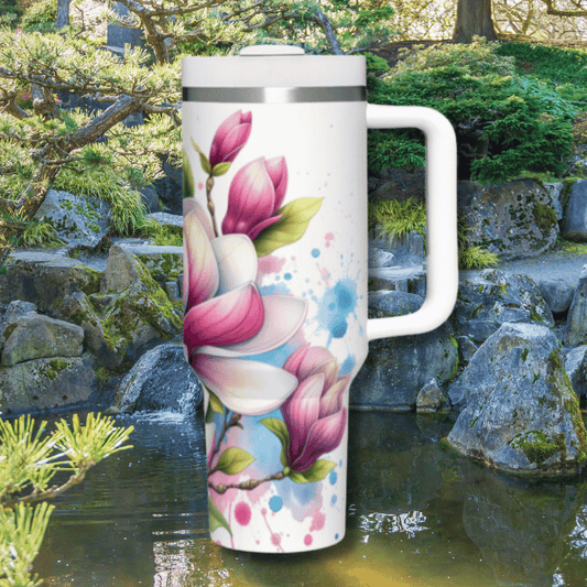 a white coffee mug with pink flowers painted on it