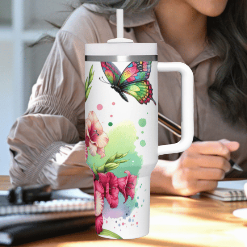 a woman sitting at a desk holding a coffee cup