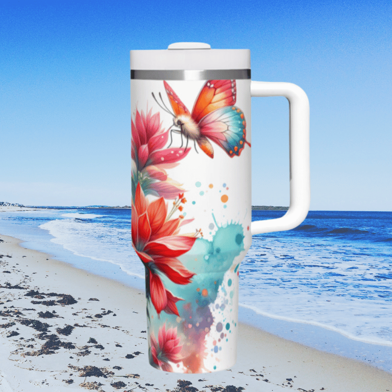 a white coffee cup sitting on top of a sandy beach