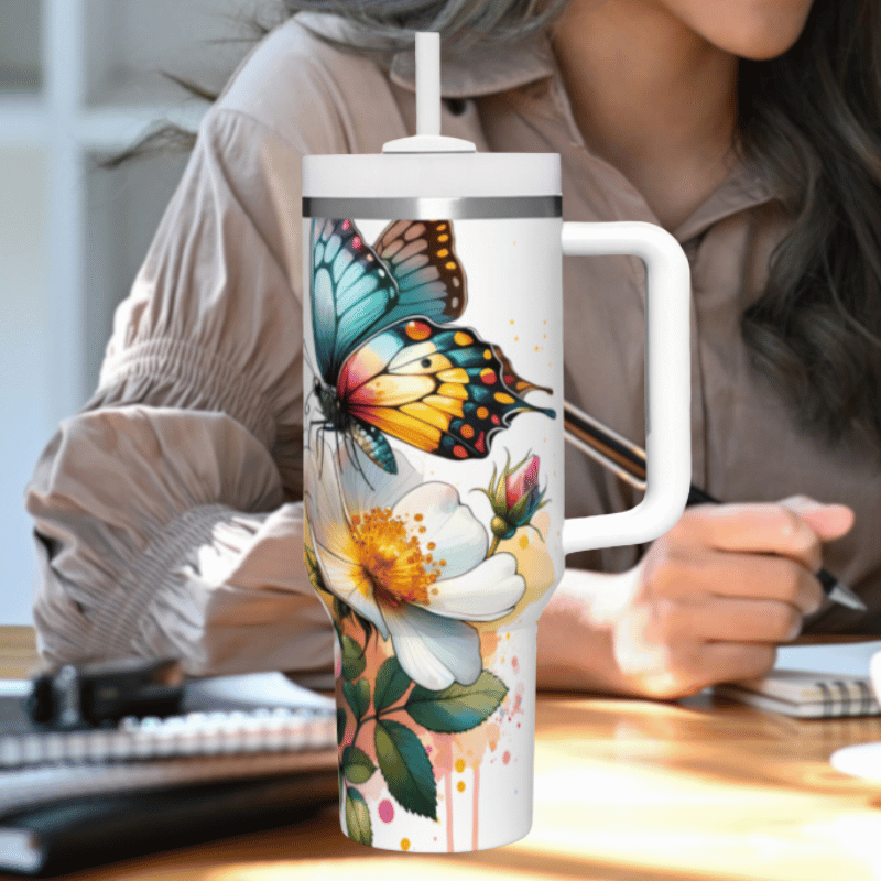 a woman sitting at a desk holding a coffee mug