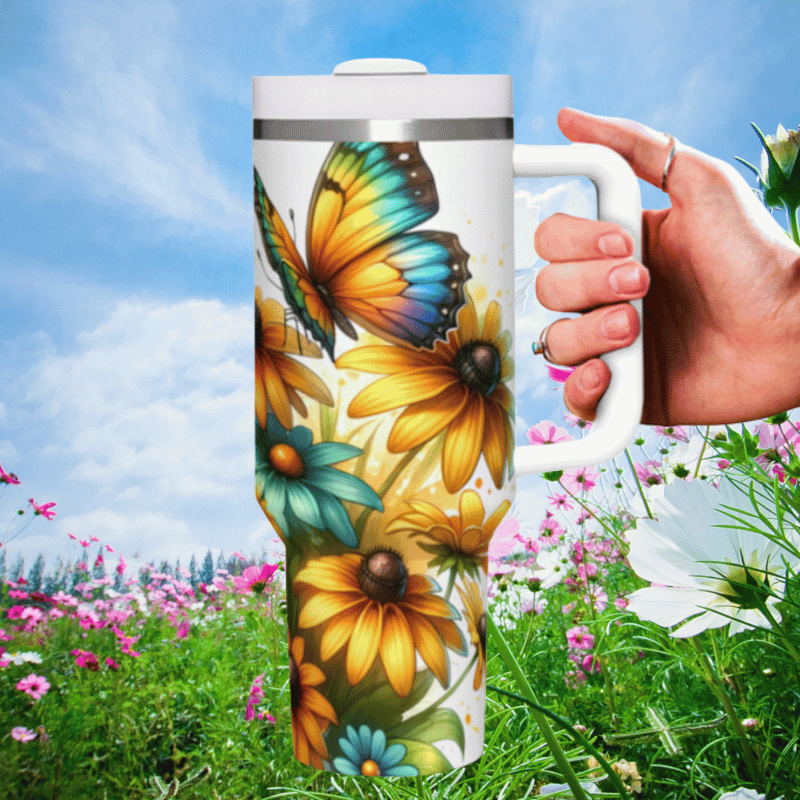 a hand holding a coffee mug in a field of flowers