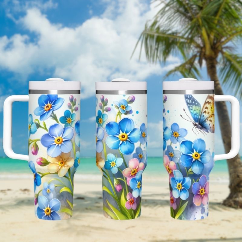 three travel mugs sitting on a beach with a palm tree in the background