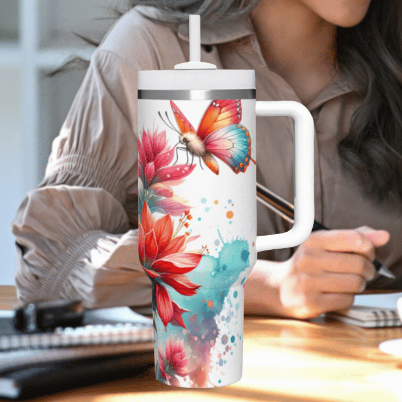 a woman sitting at a desk holding a coffee mug