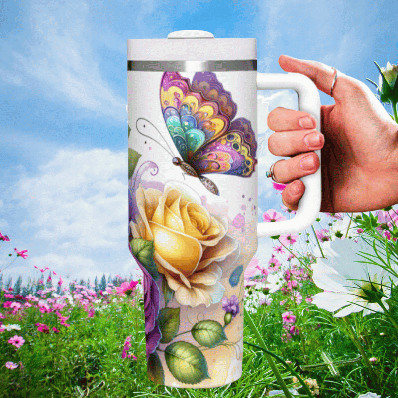 a hand holding a coffee mug in a field of flowers