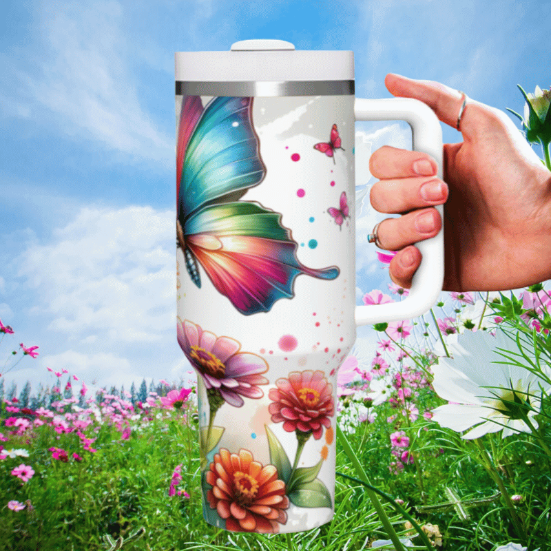 a hand holding a coffee mug in a field of flowers